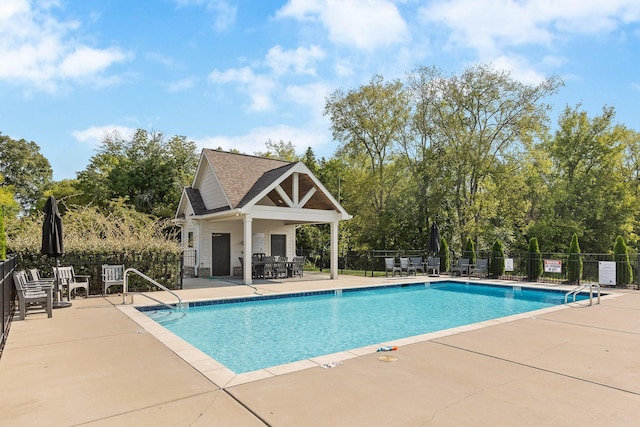 2305 Weeping Willow Dr, Ooltewah, TN 37363 - community pool with a patio, an outbuilding, and view of wooded area
