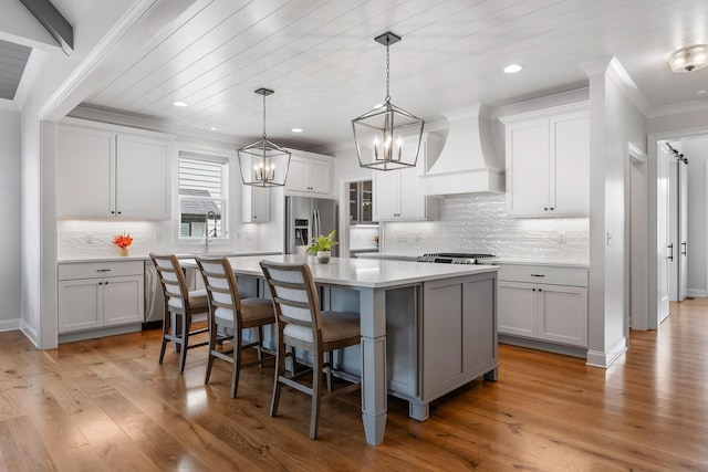 2305 Weeping Willow Dr, Ooltewah, TN 37363 - kitchen featuring custom range hood, stainless steel fridge, a chandelier, light countertops, and a kitchen island