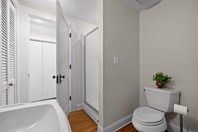 402 Fairview Dr, Dalton, GA 30720 - bathroom featuring a closet, wood finished floors, an enclosed shower, and a baseboard heating unit
