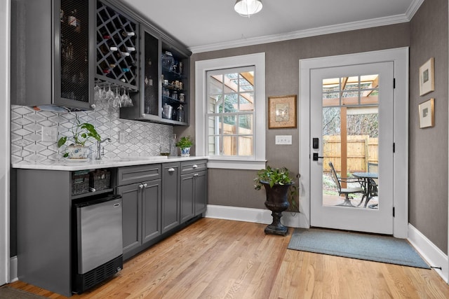 402 Fairview Dr, Dalton, GA 30720 - indoor bar featuring light wood-type flooring, decorative backsplash, and crown molding