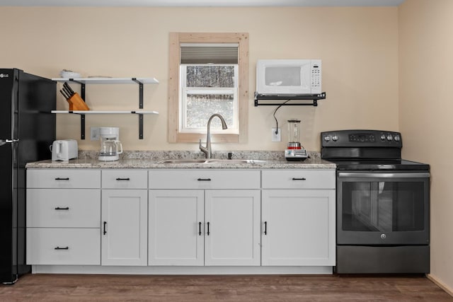 1080 Harp Switch Rd, Chickamauga, GA 30707 - kitchen with range with electric cooktop, white microwave, white cabinetry, open shelves, and dark wood-type flooring