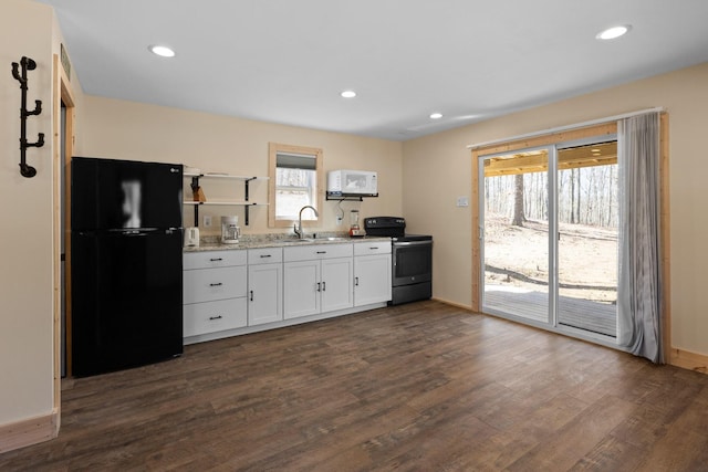 1080 Harp Switch Rd, Chickamauga, GA 30707 - kitchen with freestanding refrigerator, range with electric cooktop, white cabinets, dark wood-style flooring, and plenty of natural light
