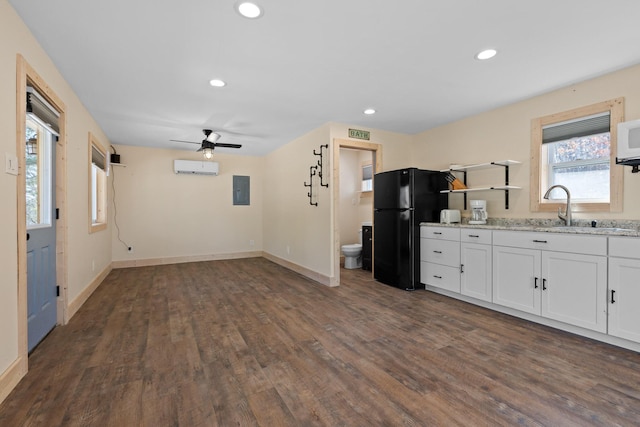 1080 Harp Switch Rd, Chickamauga, GA 30707 - kitchen featuring freestanding refrigerator, electric panel, a wall mounted air conditioner, white cabinets, and dark wood-style floors