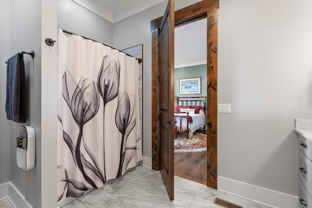 6835 Jasper Highlands Blvd, Jasper, TN 37347 - ensuite bathroom with marble look tiles, vanity, crown molding, and a shower with shower curtain