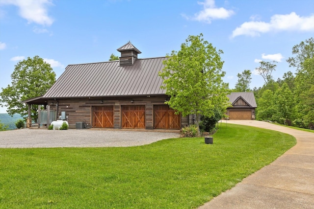 6835 Jasper Highlands Blvd, Jasper, TN 37347 - view of front of house featuring a front yard, a metal roof, driveway, and a standing seam roof