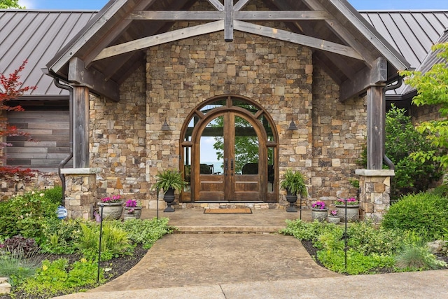 6835 Jasper Highlands Blvd, Jasper, TN 37347 - entrance to property with french doors, a standing seam roof, stone siding, and a metal roof
