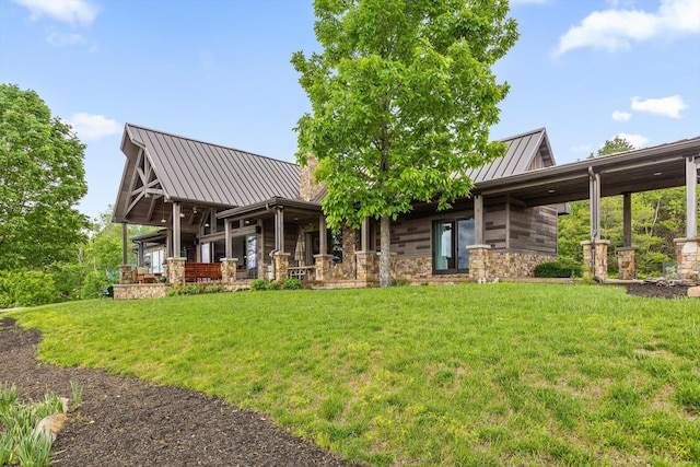 6835 Jasper Highlands Blvd, Jasper, TN 37347 - back of property featuring a standing seam roof, a yard, a metal roof, and stone siding