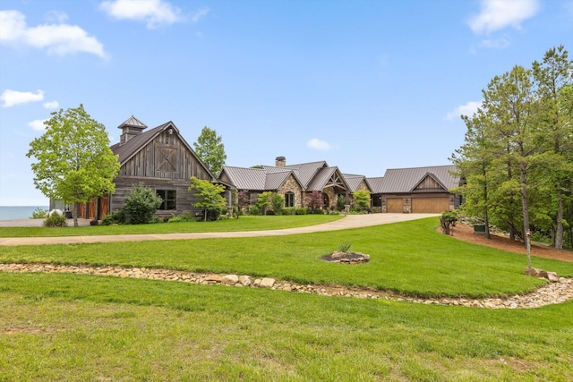 6835 Jasper Highlands Blvd, Jasper, TN 37347 - tudor home featuring a standing seam roof, concrete driveway, a front lawn, a metal roof, and a chimney