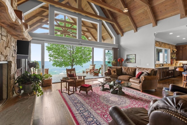 6835 Jasper Highlands Blvd, Jasper, TN 37347 - living room with high vaulted ceiling, dark wood-style floors, healthy amount of natural light, a water view, and a wooden ceiling with exposed beams