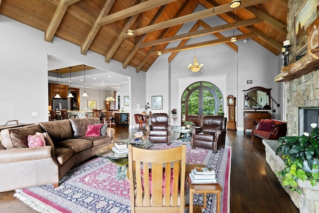 6835 Jasper Highlands Blvd, Jasper, TN 37347 - living room with a chandelier, high vaulted ceiling, dark wood-style flooring, a wooden ceiling with exposed beams, and a stone fireplace