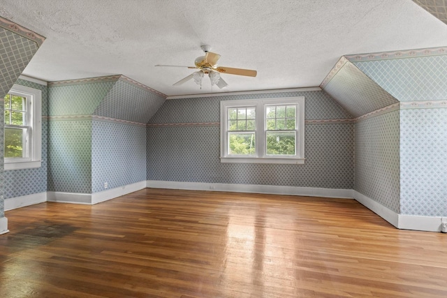 20 Ridge Rd, Chattanooga, TN 37411 - additional living space featuring wood-type flooring, wallpapered walls, a ceiling fan, vaulted ceiling, and a textured ceiling