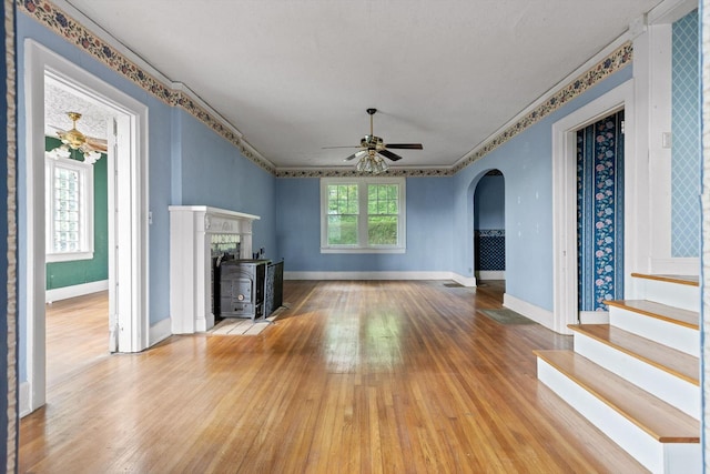 20 Ridge Rd, Chattanooga, TN 37411 - unfurnished living room with wood finished floors, arched walkways, a ceiling fan, ornamental molding, and stairway