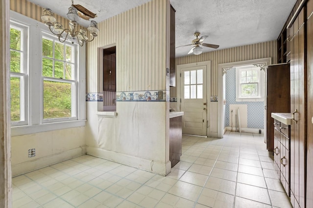 20 Ridge Rd, Chattanooga, TN 37411 - kitchen with light countertops, a chandelier, light tile patterned floors, wallpapered walls, and ceiling fan