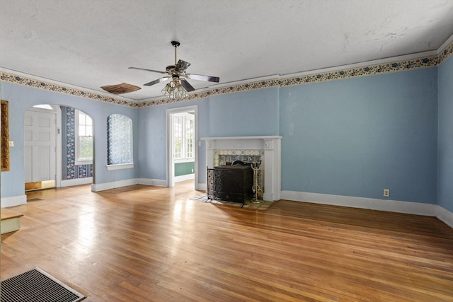 20 Ridge Rd, Chattanooga, TN 37411 - unfurnished living room with a textured ceiling, light wood-style floors, ceiling fan, and arched walkways