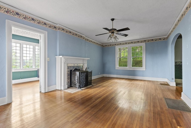 20 Ridge Rd, Chattanooga, TN 37411 - unfurnished living room with arched walkways, wood finished floors, a ceiling fan, a textured ceiling, and crown molding
