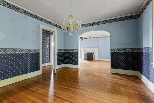 20 Ridge Rd, Chattanooga, TN 37411 - unfurnished room featuring a chandelier, a fireplace, hardwood / wood-style floors, a textured ceiling, and wainscoting