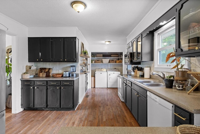 4338 Comet Trl, Hixson, TN 37343 - kitchen with dishwasher, separate washer and dryer, dark cabinetry, backsplash, and a textured ceiling