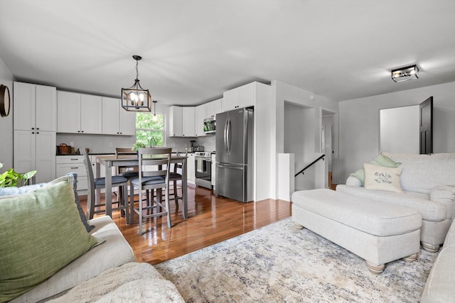 216 Trenton St, Chattanooga, TN 37415 - living room with wood finished floors and a chandelier