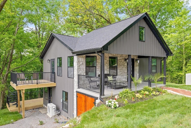 216 Trenton St, Chattanooga, TN 37415 - view of front of property with roof with shingles, stone siding, a front yard, and board and batten siding