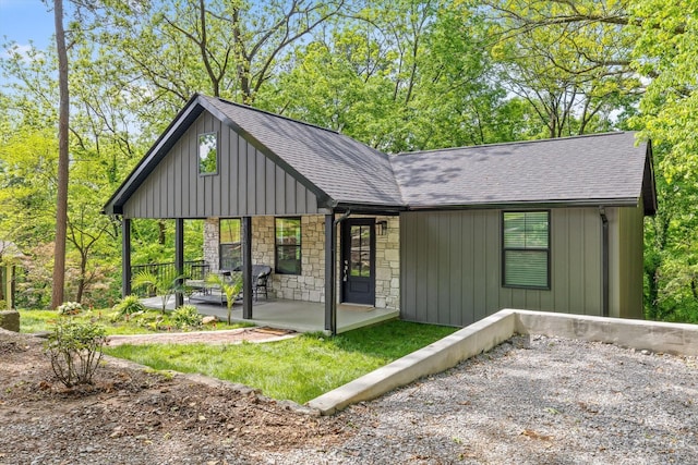 216 Trenton St, Chattanooga, TN 37415 - rear view of property with stone siding, roof with shingles, board and batten siding, and covered porch