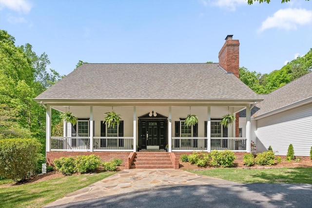 1400 Dogwood Valley Rd, Tunnel Hill, GA 30755 - view of front of house featuring a porch, a shingled roof, a chimney, and brick siding