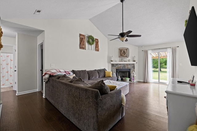 225 Shawn Ln, Chatsworth, GA 30705 - living room featuring a ceiling fan, dark wood-style flooring, lofted ceiling, a stone fireplace, and a textured ceiling