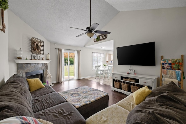 225 Shawn Ln, Chatsworth, GA 30705 - living area featuring lofted ceiling, a ceiling fan, a stone fireplace, wood finished floors, and a textured ceiling