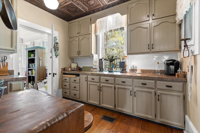 302 S Main St, La Fayette, GA 30728 - kitchen with backsplash, wood-type flooring, and dark countertops