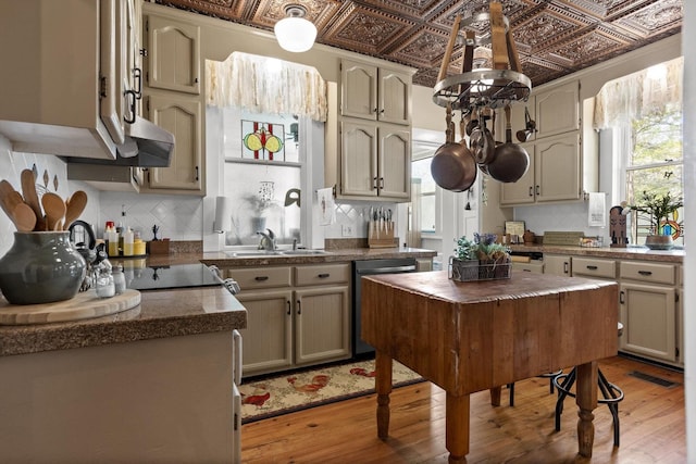 302 S Main St, La Fayette, GA 30728 - kitchen featuring dishwashing machine, an ornate ceiling, tasteful backsplash, light wood-style flooring, and dark countertops