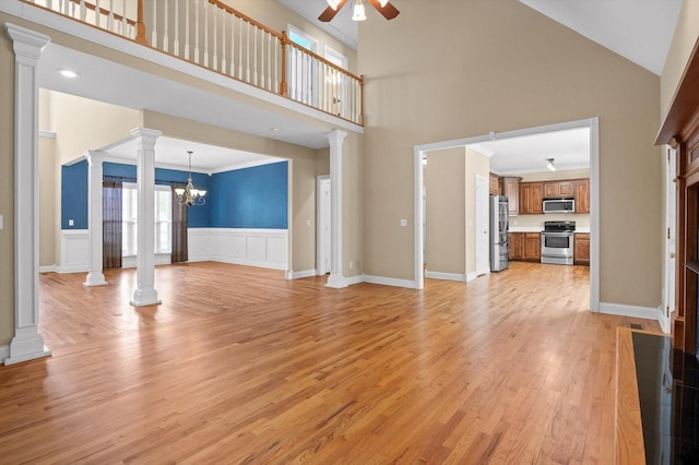 6970 Bullock Way, Hixson, TN 37343 - unfurnished living room with ornate columns, a high ceiling, a ceiling fan, light wood-style flooring, and a chandelier