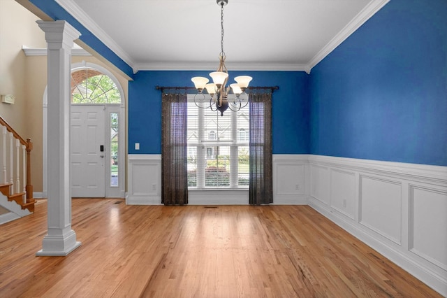 6970 Bullock Way, Hixson, TN 37343 - unfurnished dining area with stairway, a chandelier, light wood-style flooring, a wainscoted wall, and ornamental molding