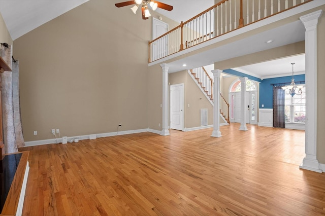 6970 Bullock Way, Hixson, TN 37343 - unfurnished living room featuring ceiling fan, light wood finished floors, stairs, ornate columns, and a chandelier