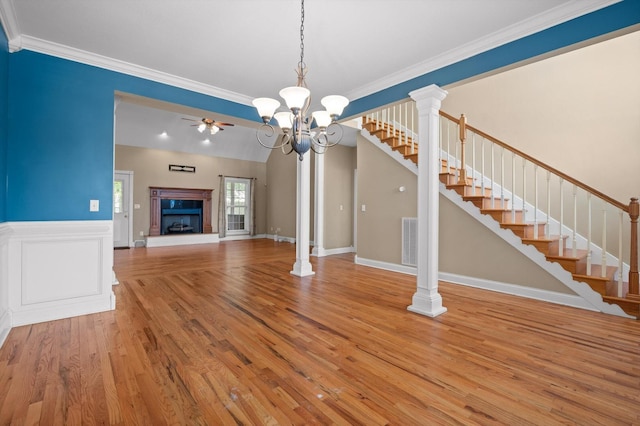 6970 Bullock Way, Hixson, TN 37343 - unfurnished living room with stairway, wood finished floors, a ceiling fan, crown molding, and a fireplace with raised hearth