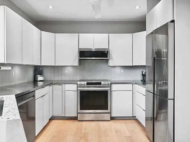 467 Wisley Way, Ringgold, GA 30736 - kitchen with appliances with stainless steel finishes, light wood finished floors, white cabinets, and recessed lighting