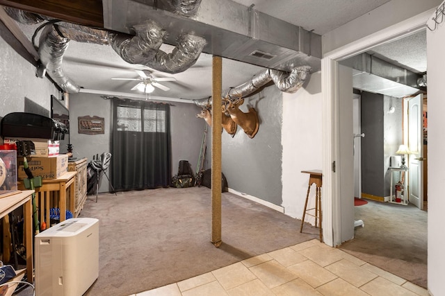 131 Sioux Trl, Ringgold, GA 30736 - below grade area with carpet floors, ceiling fan, tile patterned flooring, and a textured ceiling