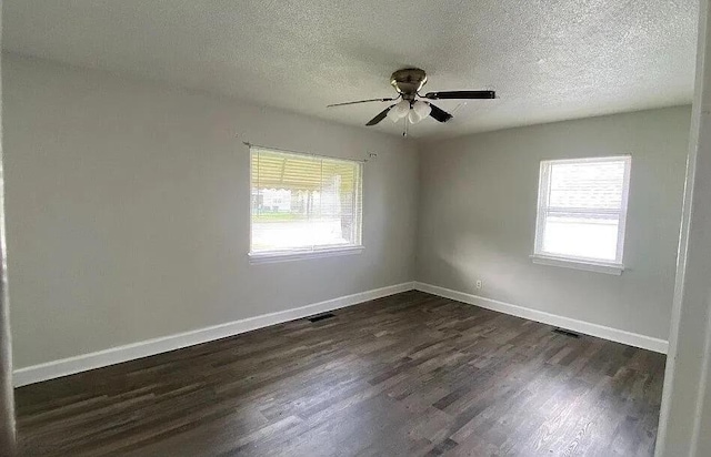 604606 N Moore Rd, Chattanooga, TN 37411 - unfurnished room with healthy amount of natural light, dark wood-style flooring, a ceiling fan, and a textured ceiling