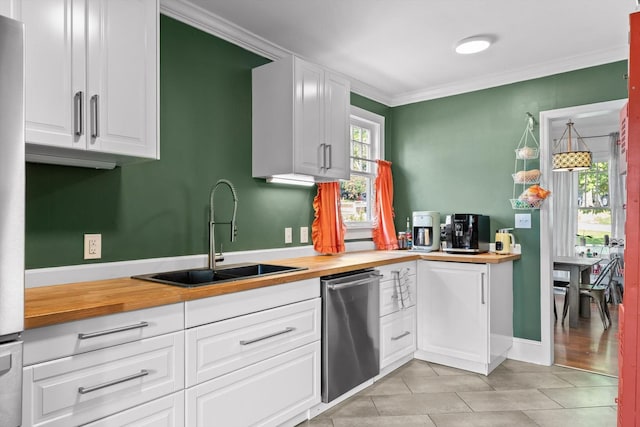 220 Hillcrest Ave, Chattanooga, TN 37411 - kitchen with wooden counters, dishwasher, white cabinetry, ornamental molding, and light tile patterned floors