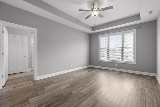 9614 Mulberry Gap Way, Ooltewah, TN 37363 - empty room with a raised ceiling, a ceiling fan, and dark wood-style flooring