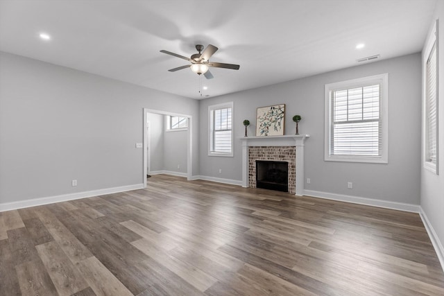 9614 Mulberry Gap Way, Ooltewah, TN 37363 - unfurnished living room featuring a ceiling fan, a brick fireplace, recessed lighting, and wood finished floors