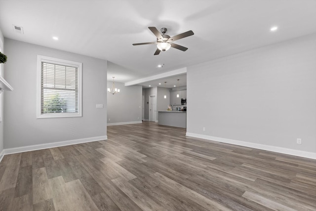 9614 Mulberry Gap Way, Ooltewah, TN 37363 - unfurnished living room with ceiling fan, a chandelier, wood finished floors, and recessed lighting