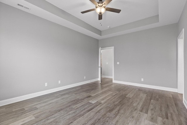 9614 Mulberry Gap Way, Ooltewah, TN 37363 - unfurnished room with a ceiling fan, wood finished floors, and a raised ceiling
