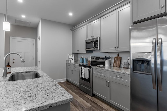 9614 Mulberry Gap Way, Ooltewah, TN 37363 - kitchen featuring appliances with stainless steel finishes, gray cabinetry, dark wood-style flooring, recessed lighting, and light stone counters