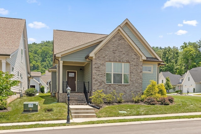 9614 Mulberry Gap Way, Ooltewah, TN 37363 - view of front of house featuring brick siding, a front yard, and roof with shingles