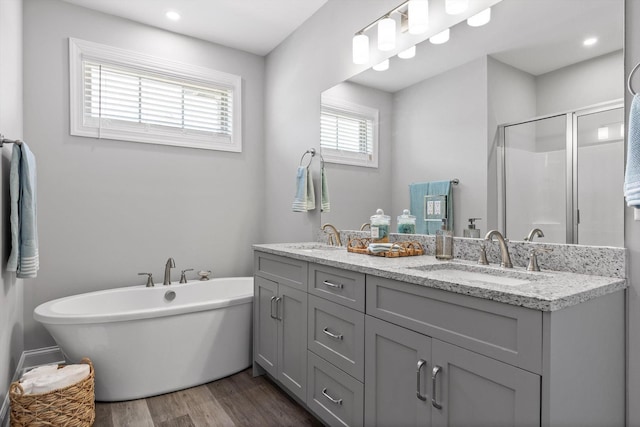 9614 Mulberry Gap Way, Ooltewah, TN 37363 - full bath with wood finished floors, double vanity, a shower stall, a freestanding bath, and recessed lighting