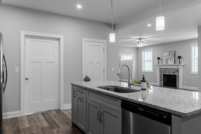 9614 Mulberry Gap Way, Ooltewah, TN 37363 - kitchen with appliances with stainless steel finishes, pendant lighting, light stone countertops, dark wood-type flooring, and an island with sink