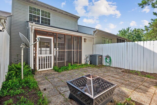 6585 Hickory Trace Cir, Chattanooga, TN 37421 - rear view of property featuring a fire pit, a patio, and a sunroom
