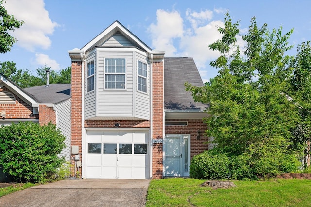 6585 Hickory Trace Cir, Chattanooga, TN 37421 - view of front facade featuring brick siding, an attached garage, concrete driveway, and a front yard