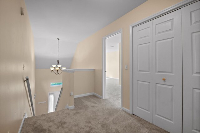 6585 Hickory Trace Cir, Chattanooga, TN 37421 - hallway featuring an upstairs landing, a chandelier, carpet flooring, and vaulted ceiling