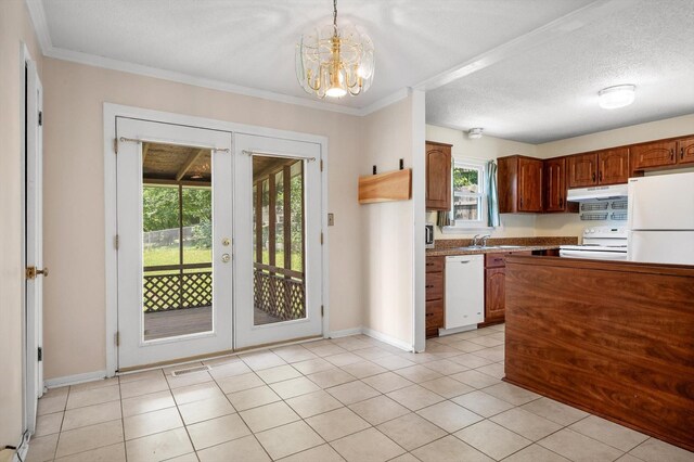 6557 Esquire Dr, Hixson, TN 37343 - kitchen with white appliances, under cabinet range hood, french doors, healthy amount of natural light, and crown molding