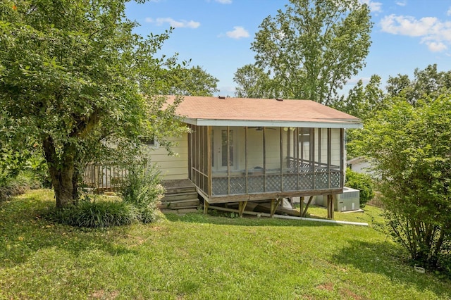 6557 Esquire Dr, Hixson, TN 37343 - back of property with a yard, a shingled roof, and a sunroom